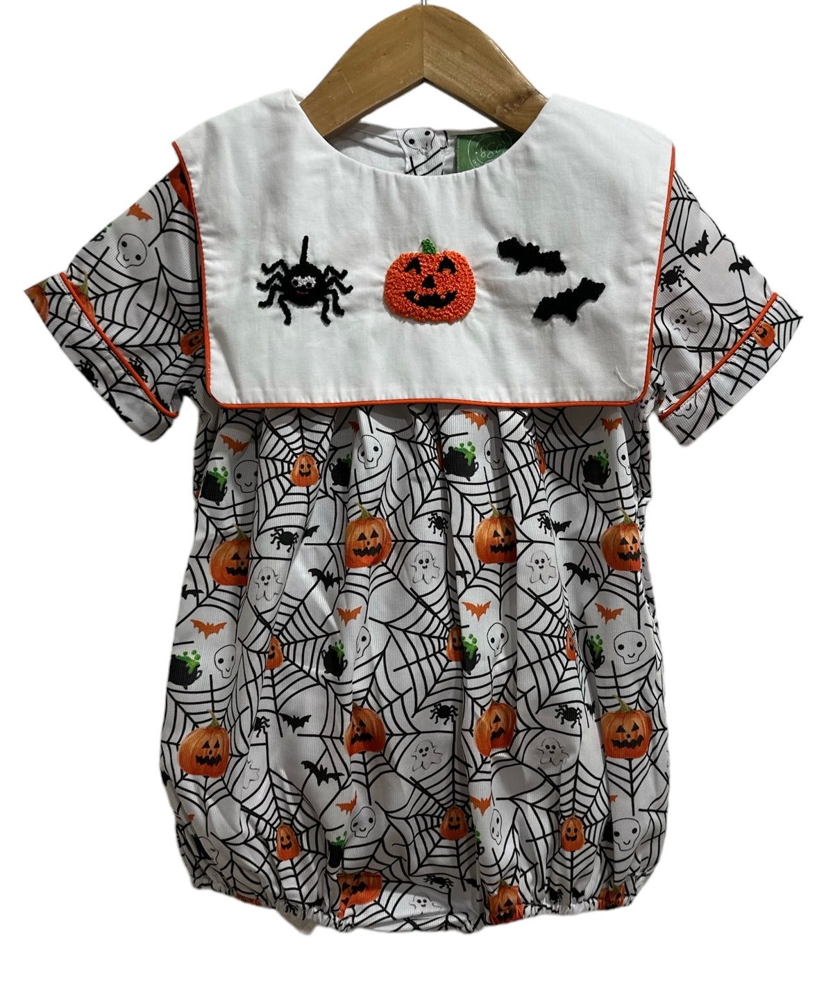 Halloween-themed baby romper with pumpkins, ghosts, and spiders on a white background.