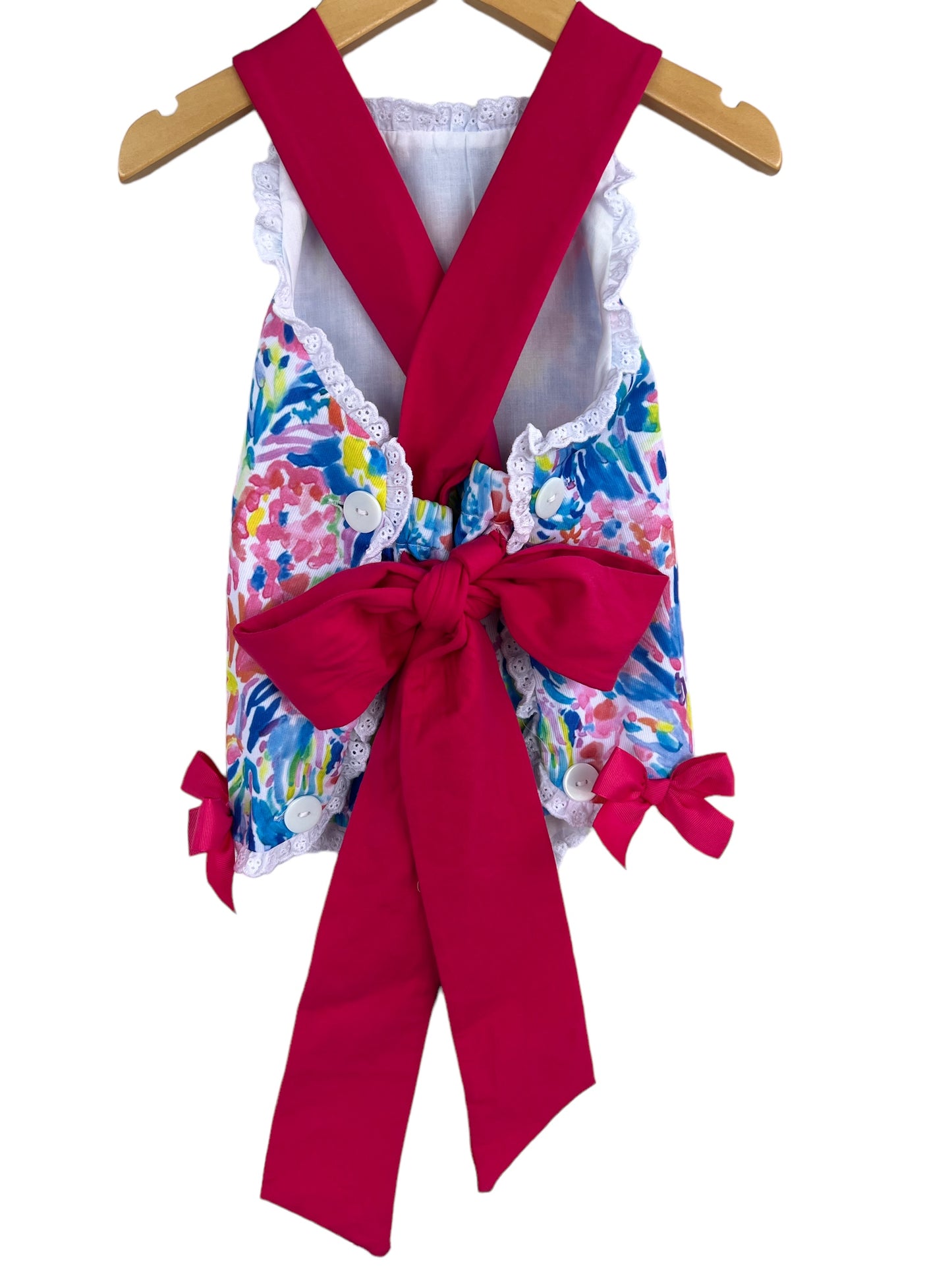 Back side of colorful sunsuit with big pink bow