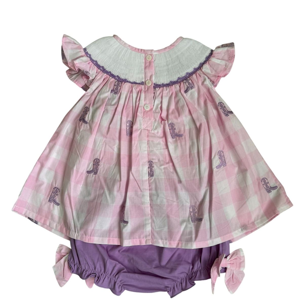Back view of girls pink gingham cowgirl boot bloomer set with ruffle sleeves, button-back closure and purple bloomers with pink bows.