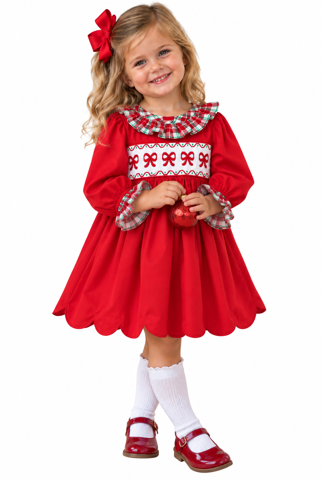 Girl  wearing hand smocked Christmas Bow Dress