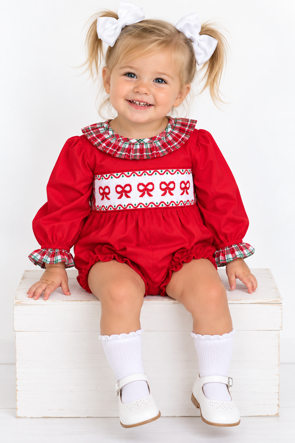 girl wearing hand smocked bow Christmas bubble