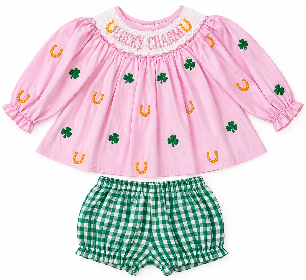 Pink girls’ Lucky Charm outfit with smocked neckline, embroidered green shamrocks and gold horseshoes, paired with green and white gingham bloomers.