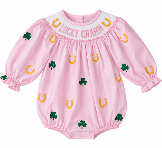 Girls’ soft pink St. Patrick’s Day bubble with hand-smocked “Lucky Charm” yoke, green shamrocks, gold horseshoes, and long sleeves.