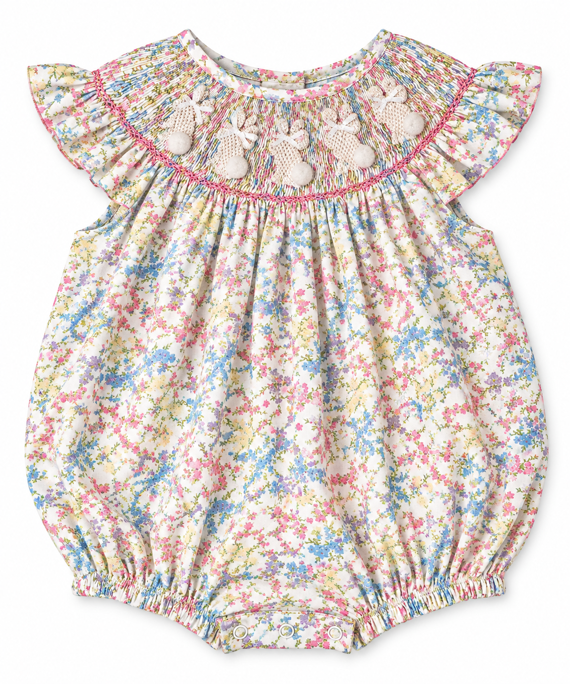 Girls Easter hand-smocked bunny floral bubble romper with flutter sleeves and pom-pom bunny tails.