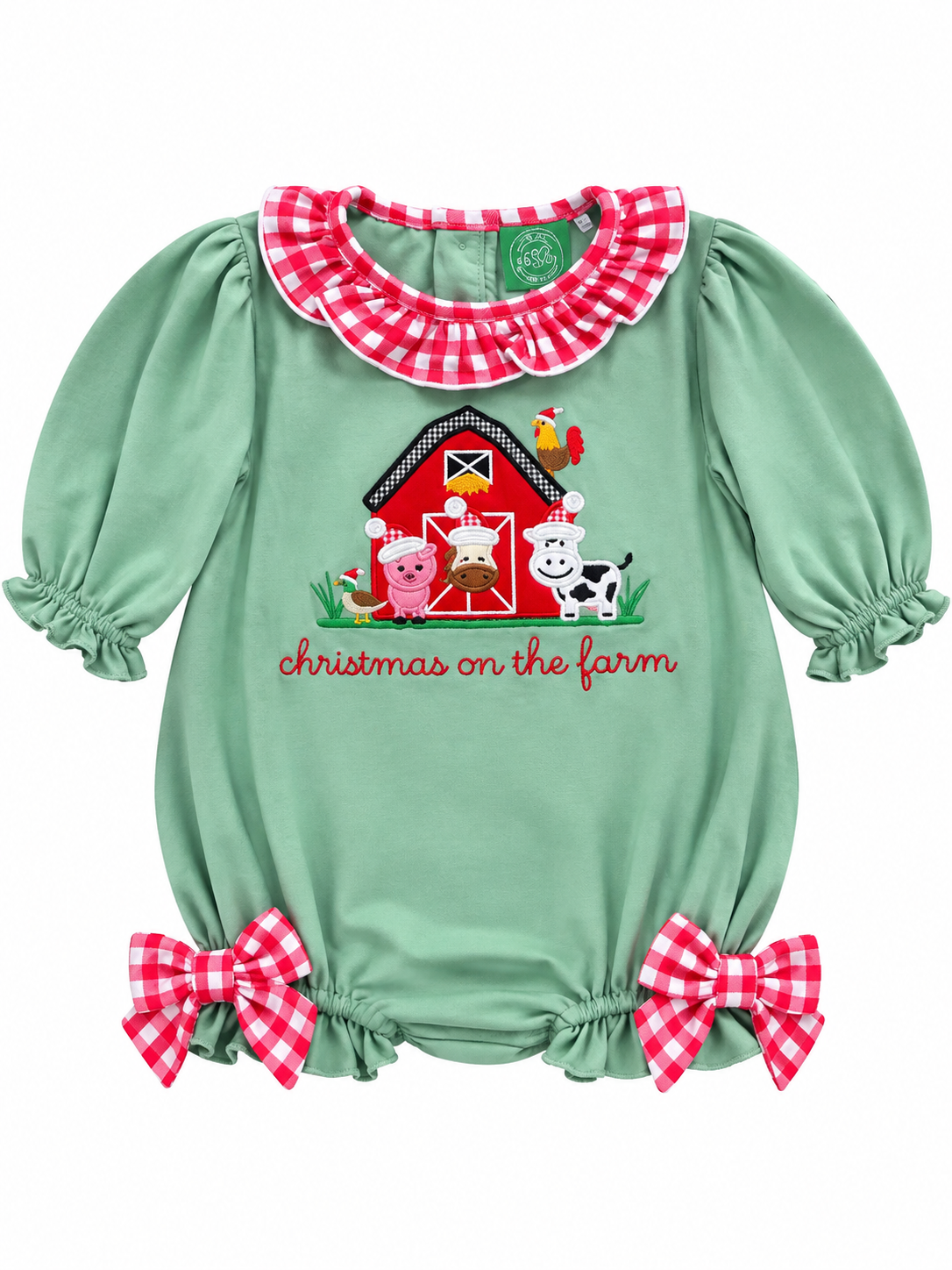 A baby girl's sage green bubble romper with a red and white gingham ruffled collar, matching gingham bows at the leg ruffles, and a central Christmas farm graphic with the text 'christmas on the farm'.