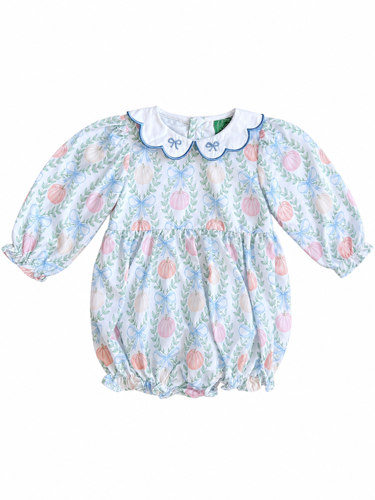 Girls long sleeve bubble romper with pastel pumpkin print, blue floral accents, and scalloped white collar with blue bow details.